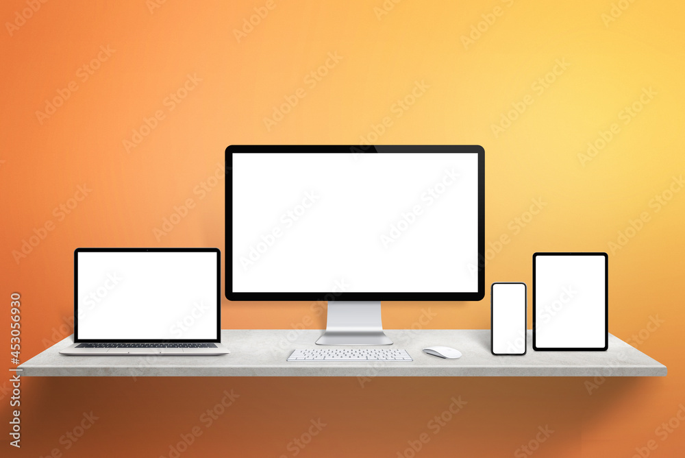 Aufkleber Responsive display devices mockup on desk. Computer display, laptop, tablet and phone with isolated screen. Orange wall in background
