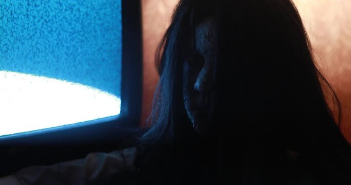 Portrait of girl in image of scary zombie in dark room.