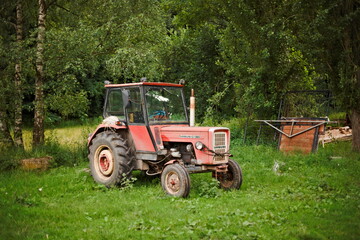 Old red agricultural tractor outdoors