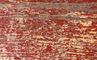 Background of a wooden board with peeled paint of brown and beige color. 