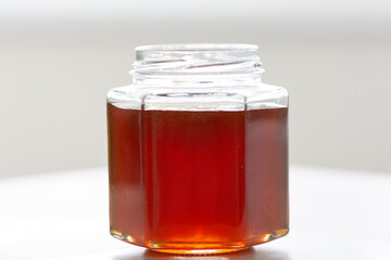 fresh natural honey in a jar in the form of a honeycomb