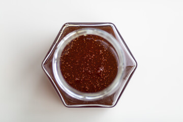 fresh natural honey in a jar in the form of a honeycomb top view