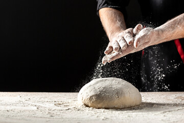 Preparing yeast dough made from wheat flour. hands knead the dough make bread, pasta or pizza