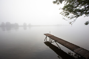 Jetty in the misty river Meuse in Geijsteren in the North of Limburg