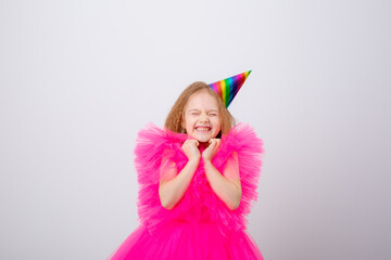 a little girl celebrates her birthday on a white background