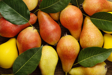 fresh pears with leaves as background, top view