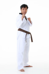 Isolated portrait studio shot of Asian middle aged male tae kwan do karate judo sport athlete in...