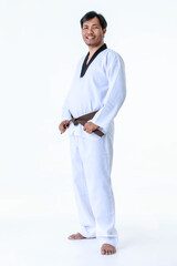 Isolated portrait studio shot of Asian middle aged male tae kwan do karate judo sport athlete in uniform with brown belt standing look at camera posing strong gesture in front of white background