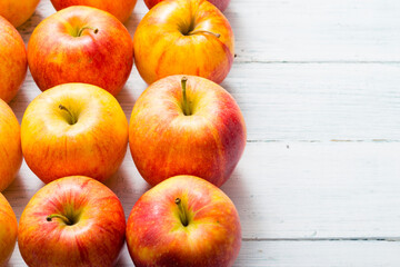 apple fruits in a row, white wooden table background