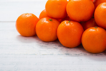 pyramid stack of mandarin oranges on shabby chic white wood table background