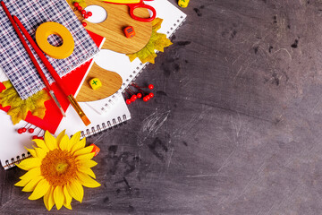 School supplies on a black chalkboard background