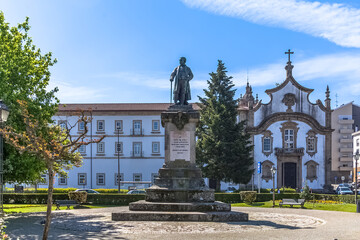 View at the St. Cristina Garden with the Alves Martins bishop statue, Church of the Major Seminary of Viseu, Seminário Maior de Viseu, Convento dos Néris as background - obrazy, fototapety, plakaty