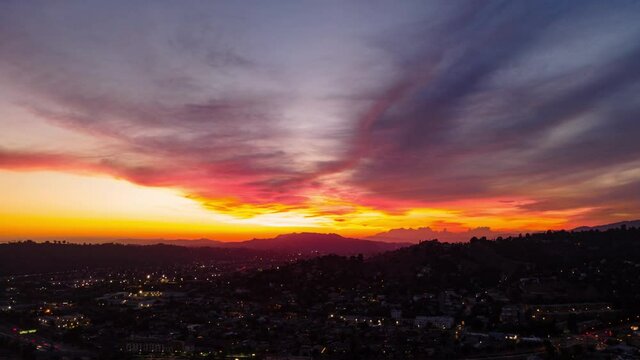 Aerial hyperlapse of epic sunset sky over Los Angeles skyline