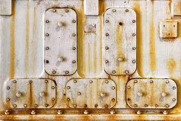 Metal hatches plate on compressor for revision closeup with oil and rust painted with gray paint bolted with studs and nuts steampunk background with copyspace.
