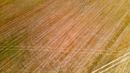 Aerial top view of a country road through a field in summer. Texture for design. Space for text.