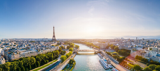 Paris aerial panorama with river Seine and Eiffel tower, France. Romantic summer holidays vacation destination. Panoramic view above historical Parisian buildings and landmarks with blue sky and sun - obrazy, fototapety, plakaty