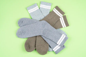 Set of warm socks on a pistachio-colored background