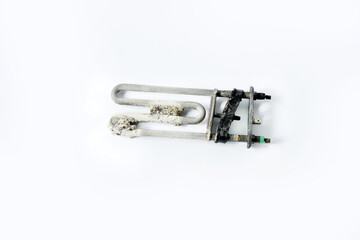 Washing machine heating element covered with limescale, corrosion and rust on a white background.