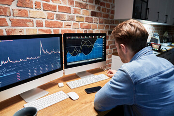 Obraz na płótnie Canvas Man following stock market data