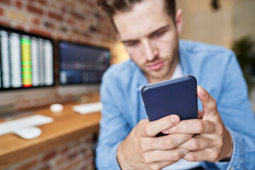 Man using phone to follow stock market