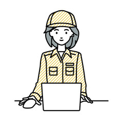 デスクで座ってPCを使っている作業員の女性