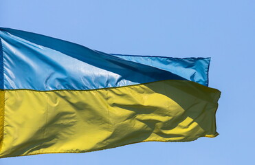 flag and coat of arms of Ukraine on sky background