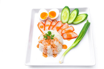 Rice with Roasted red pork was served with boiled egg which on top with sweet red sauce and decorated fresh chopped cucumber and spring Onion It’s a Asian Food fusion style or street foodof Thailand.