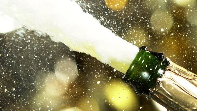 Super slow motion of Champagne explosion, opening champagne bottle closeup. Filmed on high speed cinema camera, 1000fps.