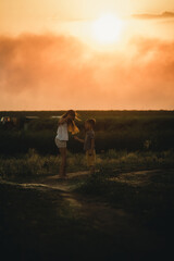Obraz na płótnie Canvas brother and sister play at sunset