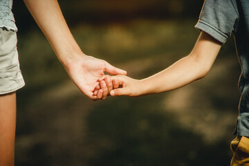 children holding hands close-up for background