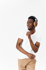 a man in headphones in a white t-shirt listens to music emotions