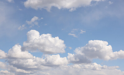Naklejka na ściany i meble Bright white clouds over blue sky