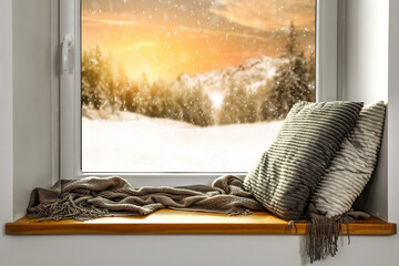 Winter window background with pillows and free space for your decoration 
