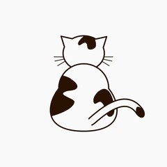 A cat sitting alone facing back