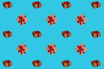 Pattern of gift boxes with a bow made with ribbon isolated on a light blue background