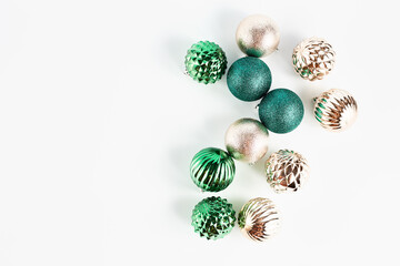holiday banner. christmas decor on a light background. balloons of gold and green in a festive composition. top view, copy space
