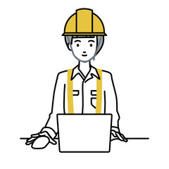 デスクで座ってPCを使っている工事現場の女性