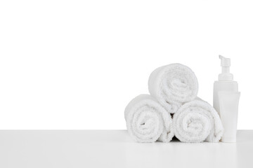Fototapeta na wymiar Composition of cosmetic bottles and towels isolated on white