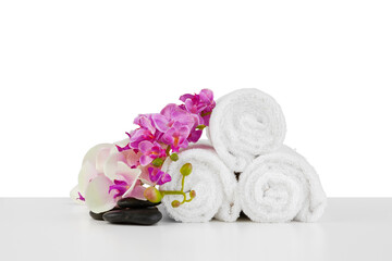Spa composition with towels and flowers isolated on white
