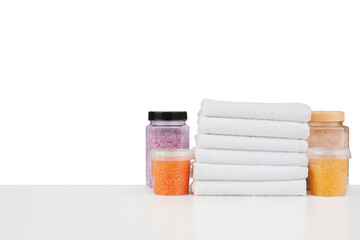 Composition of cosmetic bottles and towels isolated on white