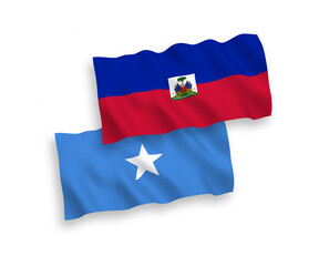 National vector fabric wave flags of Republic of Haiti and Somalia isolated on white background. 1 to 2 proportion.