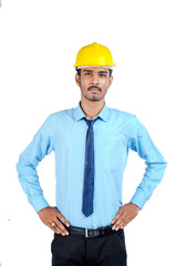 Young Indian male engineer wearing yellow color hard hat on white background.