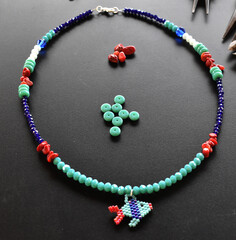 A multicolor necklace on a black background
