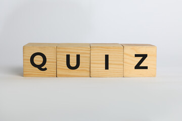 Wooden cubes with word Quiz on white background