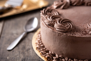 Piece of chocolate truffle cake on wooden table