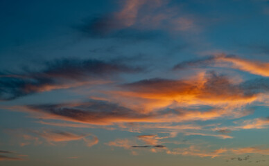 Sunset sky with orange clouds. Nature background.