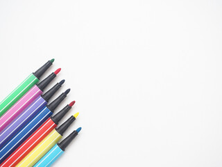 Close up color pen different array on white isolated top view copy space