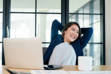 Young businesswoman relaxing at workplace in office.