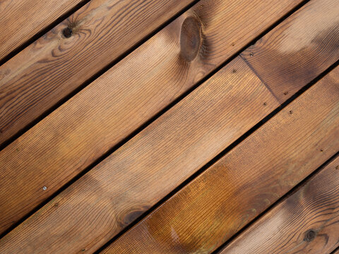 Des planches de bois en sapin douglas sur une terrasse ext&eacute;rieure mouill&eacute;e
