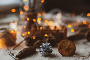 Christmas New Year top view of handmade crafts with pine cones, dry round slices of oranges, garland, branches. New year holiday, celebration concept